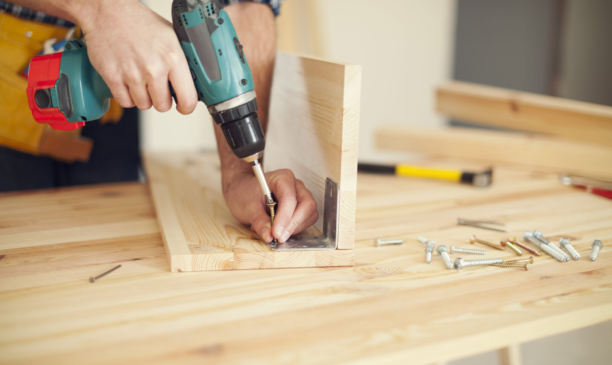 Close up of carpenter working with drill